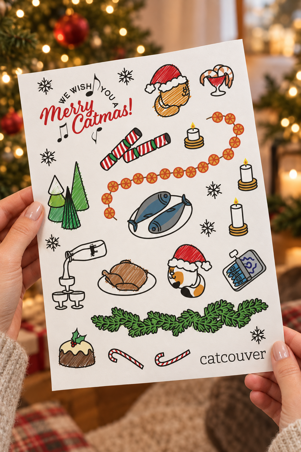 Merry Catmas sticker sheet held at an angle in a festive room